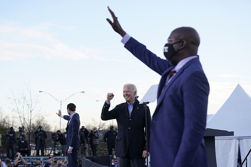 Photo by Carolyn Kaster of The Associated Press / President-elect Joe Biden campaigns in Atlanta on Monday, Jan. 4, 2021, for Senate candidates Raphael Warnock, right, and Jon Ossoff, left.