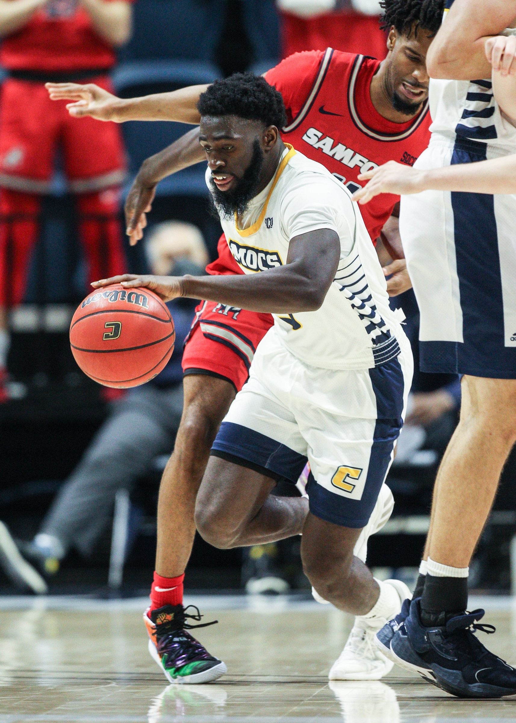 Staff photo by Troy Stolt / Chattanooga Mocs guard David Jean-Baptiste (3) scoops up a loose ball during the UTC home basketball game against Samford at Mckenzie Arena on Wednesday, Jan. 6, 2021 in Chattanooga, Tenn.