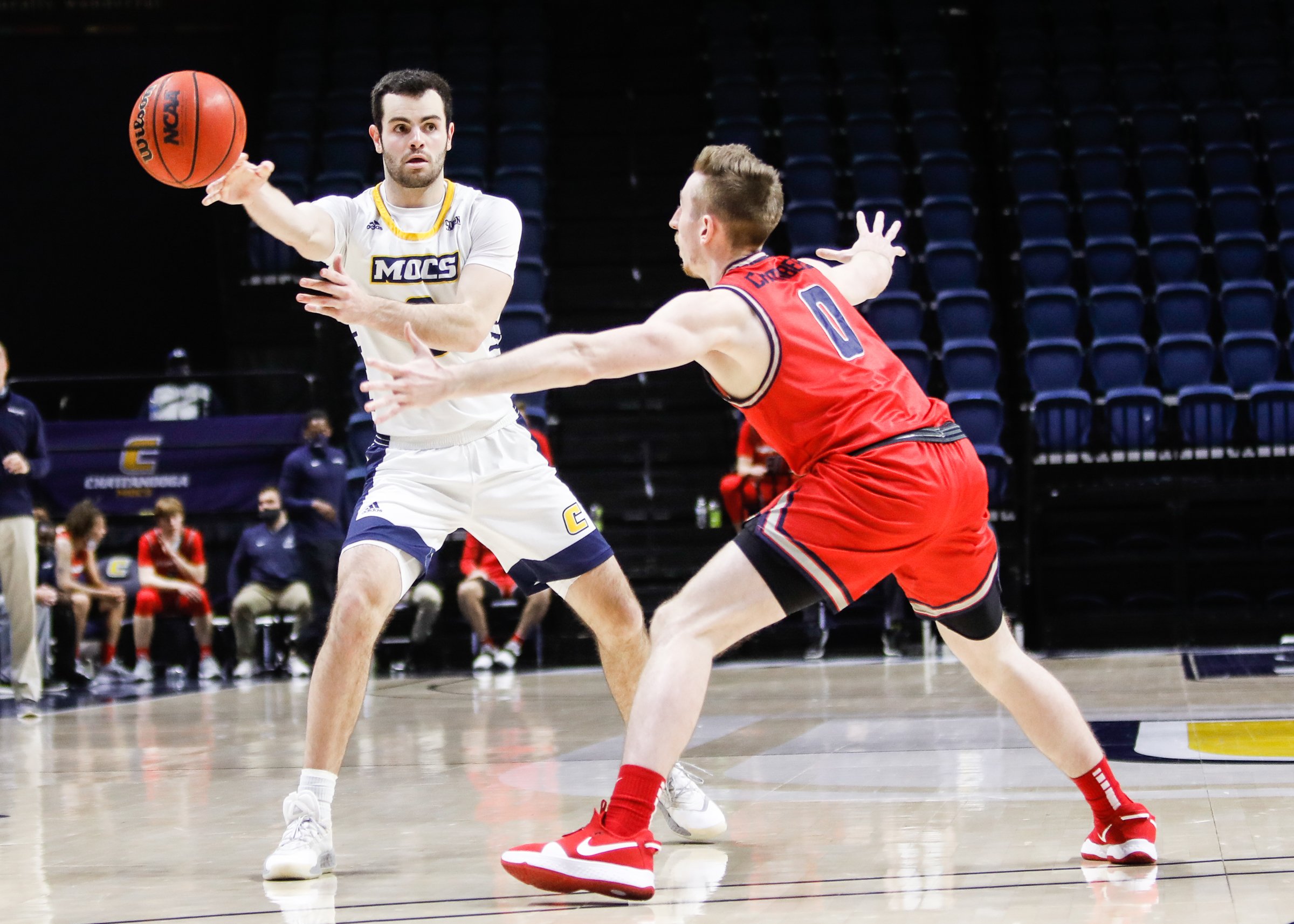 Staff photo by Troy Stolt / UTC guard A.J. Caldwell, left, passes the ball during a home game against Samford on Jan. 6.