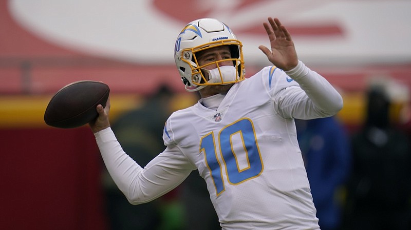 Los Angeles Chargers quarterback Justin Herbert warms up before the start of an NFL football game against the Kansas City Chiefs Sunday, Jan. 3, 2021, in Kansas City, Mo. (AP Photo/Jeff Roberson)



