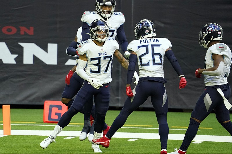 Tennessee Titans' Amani Hooker (37) celebrates with teammates after intercepting a pass during the first half of an NFL football game against the Houston Texans Sunday, Jan. 3, 2021, in Houston. (AP Photo/Sam Craft)
