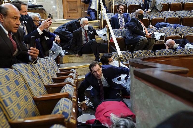 The Associated Press / People shelter in the gallery as protesters try to break into the House chamber at the U.S. Capitol in Washington, D.C., Wednesday.