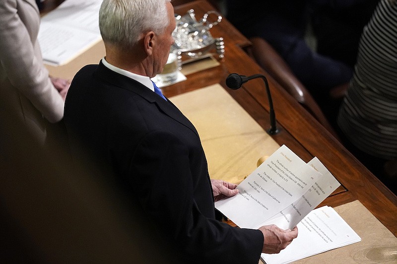 Vice President Mike Pence announces the election of President and Vice President as he officiates a joint session of the House and Senate to confirm Electoral College votes at the Capitol, early Thursday, Jan 7, 2021, in Washington. (AP Photo/Andrew Harnik)