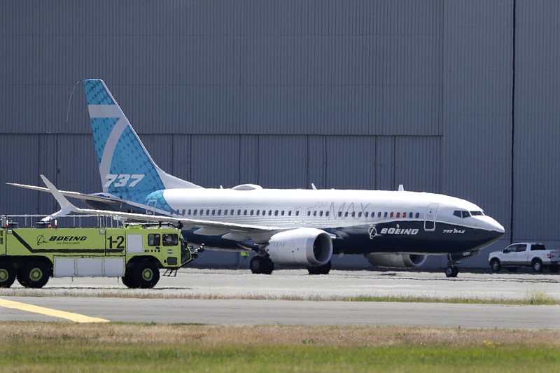 In this Monday, June 29, 2020, file photo, A Boeing 737 MAX jet taxis after landing at Boeing Field following a test flight in Seattle. Boeing will pay $2.5 billion to settle a criminal charge related to its troubled 737 Max jetliner. The Justice Department announced the settlement Thursday, Jan. 7, 2021 nearly two years after the second of two crashes that killed 346 people in all. (AP Photo/Elaine Thompson)