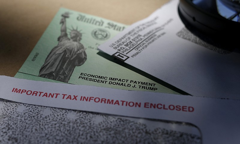 FILE - In this April 23, 2020, file photo, President Donald Trump's name is seen on a stimulus check issued by the IRS to help combat the adverse economic effects of the COVID-19 outbreak, in San Antonio. The U.S. Treasury and IRS have sent out the bulk of the second economic impact payments, which are intended to provide some relief to Americans. However, frustration is high among millions of people who did not receive payments yet and must wait for the mail or file their taxes before they receive it. (AP Photo/Eric Gay, File)