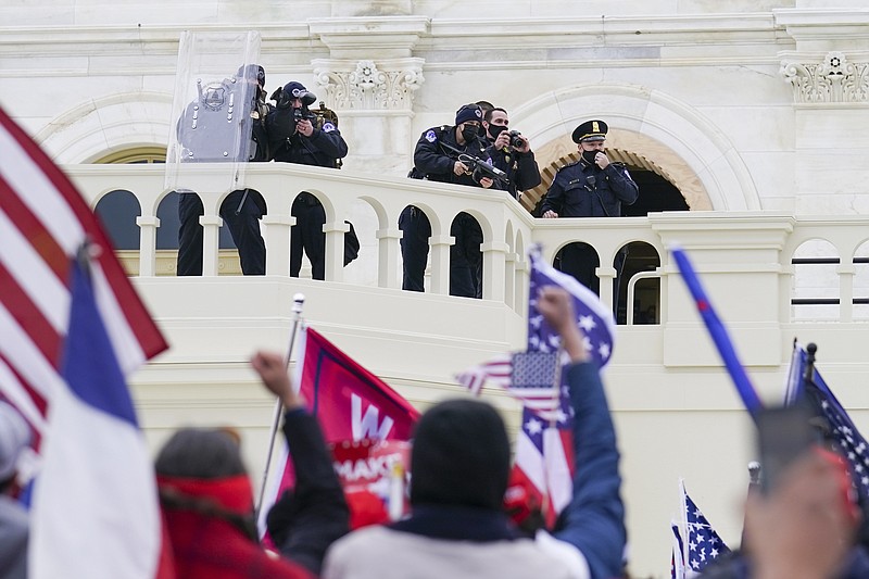 Photo by John Minchillo of The Associated Press / Supporters loyal to President Donald Trump clash with authorities before successfully breaching the Capitol building during a riot on the grounds on Wednesday, Jan. 6, 2021.