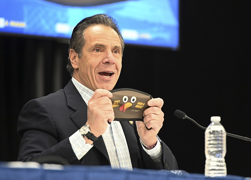 Associated Press File Photo / New York Gov. Andrew Cuomo holds up a new Thanksgiving-themed face mask during his daily coronavirus briefing at the Wyandanch-Wheatley Heights Ambulance Corp. Headquarters in Wyandanch in November.