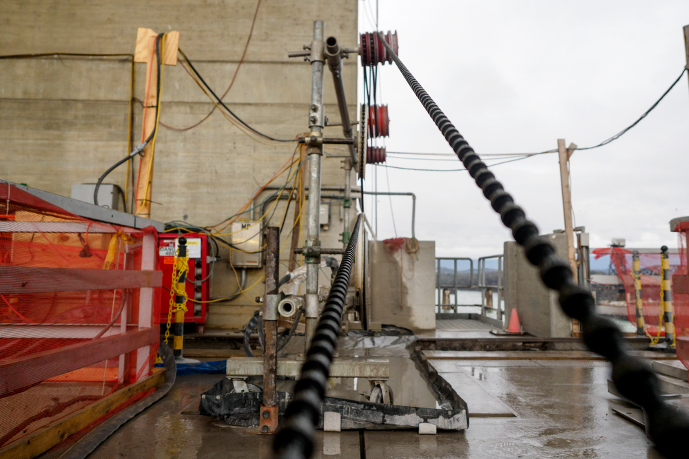 Staff photo by C.B. Schmelter / A steel cable with 15-millimeter diamond beads run through a series of pulleys atop the Chickamauga Dam on Friday, Jan. 8, 2021 in Chattanooga, Tenn. The cable is part of a diamond wire saw used to cut through the dam to allow for expansion of the concrete.