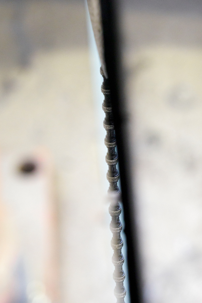 Staff photo by C.B. Schmelter / A steel cable with 15-millimeter diamond beads is seen through a cut made by the band atop the Chickamauga Dam on Friday, Jan. 8, 2021 in Chattanooga, Tenn. The cable is part of a diamond wire saw used to cut through the dam to allow for expansion of the concrete.