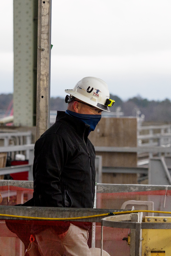 Staff photo by C.B. Schmelter / Civil Engineer Daniel Moore walks by the diamond wire saw atop the Chickamauga Dam on Friday, Jan. 8, 2021 in Chattanooga, Tenn.