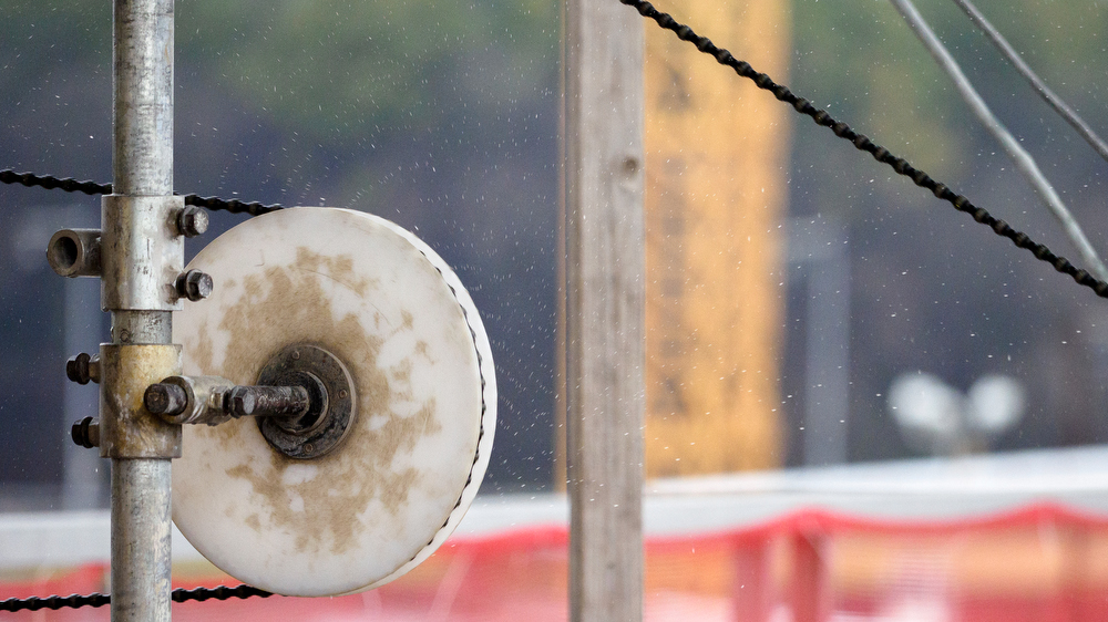 Staff photo by C.B. Schmelter / Water flies as a steel cable with 15-millimeter diamond beads moves through pulleys and cuts the concrete at the Chickamauga Dam on Friday, Jan. 8, 2021 in Chattanooga, Tenn.