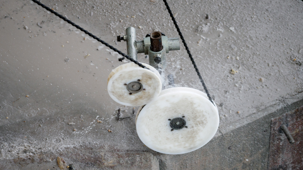 Staff photo by C.B. Schmelter / Water flies as a steel cable with 15-millimeter diamond beads moves through pulleys on the upstream side of the Chickamauga Dam on Friday, Jan. 8, 2021 in Chattanooga, Tenn.