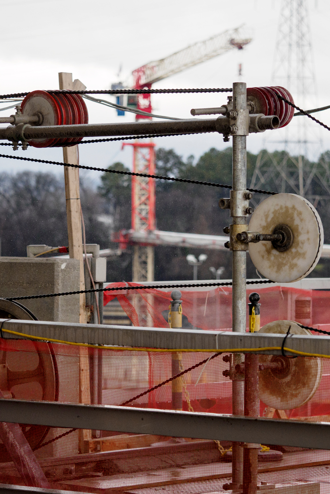 Staff photo by C.B. Schmelter / A steel cable with 15-millimeter diamond beads moves through pulleys and cuts the concrete at the Chickamauga Dam on Friday, Jan. 8, 2021 in Chattanooga, Tenn.