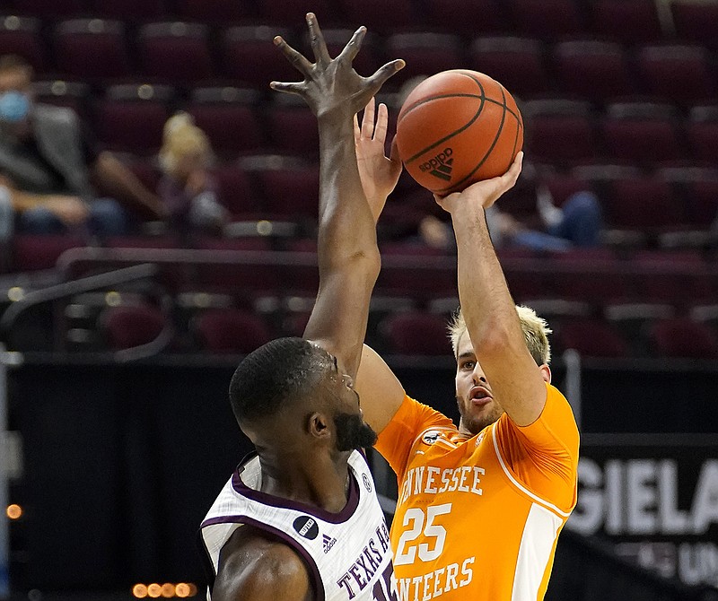 AP photo by Sam Craft / Tennessee guard Santiago Vescovi shoots a 3-pointer over Texas A&M forward Jonathan Aku during the first half of Saturday's SEC matchup in College Station. Vescovi shot 6-for-10 from 3-point range in a 23-point performance to lead the visiting Vols to a 68-54 win.