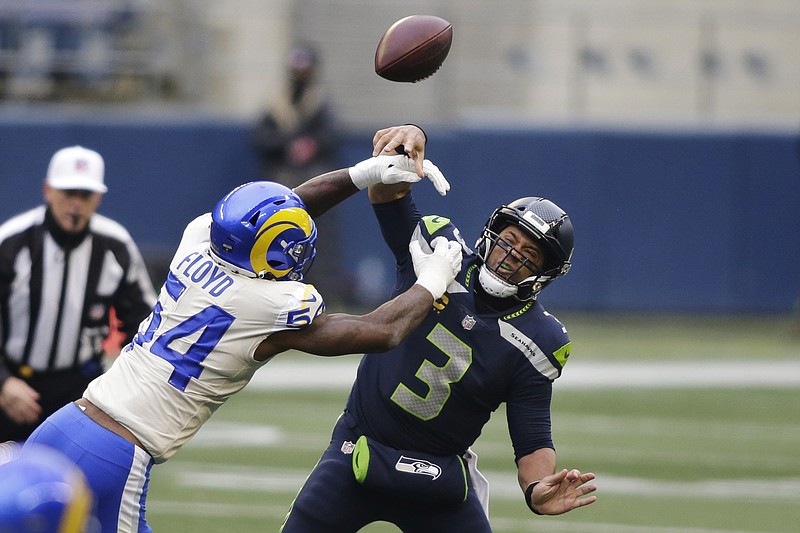 AP photo by Scott Eklund / Los Angeles Rams outside linebacker Leonard Floyd knocks the ball away as Seattle Seahawks quarterback Russell Wilson tries to pass during the first half of Saturday's NFC wild-card playoff game. The Rams won 30-20 in Seattle.