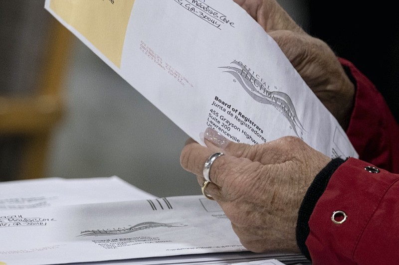 Workers at the Gwinnett County Georgia elections headquarters process absentee ballots for Georgia's Senate runoff election in Lawrenceville, Ga. on Wednesday, Jan. 6, 2021. (AP Photo/Ben Gray)


