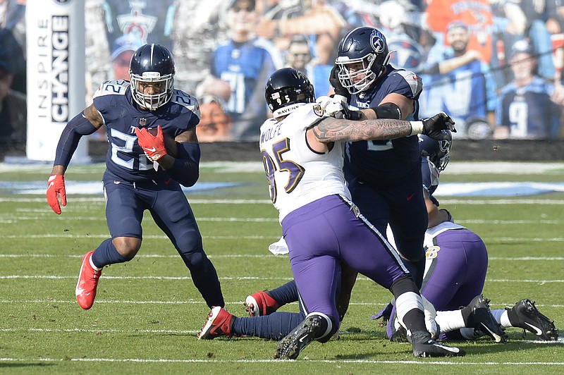 AP photo by Mark Zaleski / Tennessee Titans running back Derrick Henry, left, carries the ball as Baltimore Ravens defensive end Derek Wolfe is blocked in the first half of Sunday's AFC wild-card playoff matchup in Nashville. Henry was held to just 40 yards on 18 carries after rushing for more than 2,000 yards during the regular season, and the Titans' postseason ended quickly with a 20-13 loss to the Ravens.