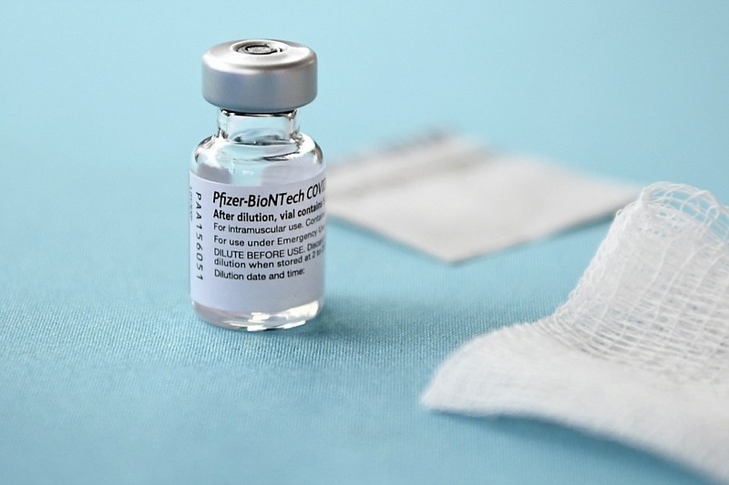 FILE - This Monday, Dec. 14, 2020 file photo, shows a vial of the Pfizer-BioNTech vaccine for COVID-19 at Hartford Hospital in Hartford, Conn. New research suggests that Pfizer's COVID-19 vaccine can protect against a mutation found in two contagious variants of the coronavirus that erupted in Britain and South Africa. Britain races to vaccinate more than 15 million people by mid-February, and in an effort to ensure vaccines get to the right places at the right times, along with the syringes, alcohol swabs and protective equipment needed to administer them, the government has called in the army. (AP Photo/Jessica Hill, File)