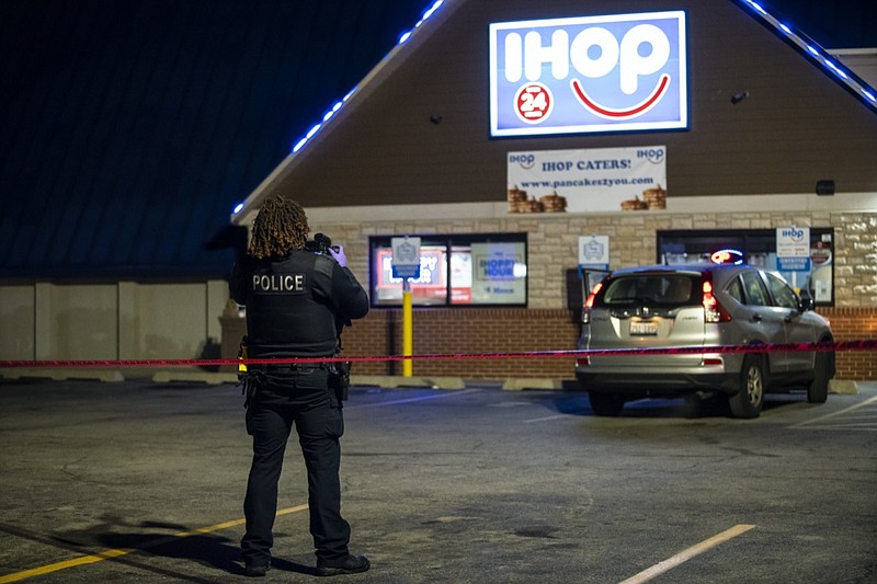 Chicago and Evanston police investigate the scene of a shooting outside an IHOP restaurant in Evanston, Ill., Saturday night, Jan. 9, 2021. (Ashlee Rezin Garcia/Chicago Sun-Times via AP)