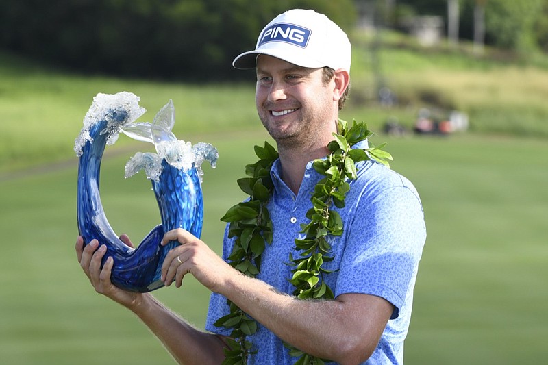 Harris English holds the champions trophy after the final round of the Tournament of Champions golf event, Sunday, Jan. 10, 2021, at Kapalua Plantation Course in Kapalua, Hawaii. (Matthew Thayer/The Maui News via AP)