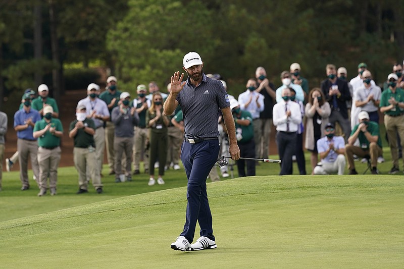 Dustin Johnson waves after winning the 2020 Masters tournament in Augusta, Ga.