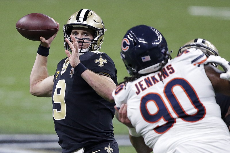 AP photo by Butch Dill / New Orleans Saints quarterback Drew Brees passes under pressure from Chicago Bears defensive tackle John Jenkins this past Sunday during an NFC wild-card playoff game.