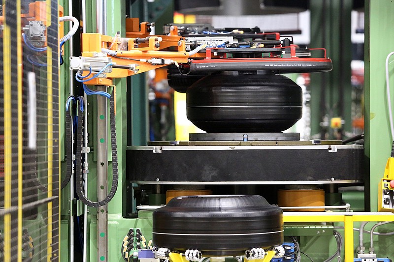 Staff file photo / Newly made tires go through the curing phase at the Nokian Tyres production plant in Dayton, Tennessee. After the curing process, tires go through a variety of inspections and tests before being put on the shipping line.