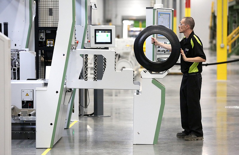 Staff file photo / Shaun Liner, a tire building machine operator the Nokian Tyres production plant in Dayton, Tennessee, works on one of the units. 