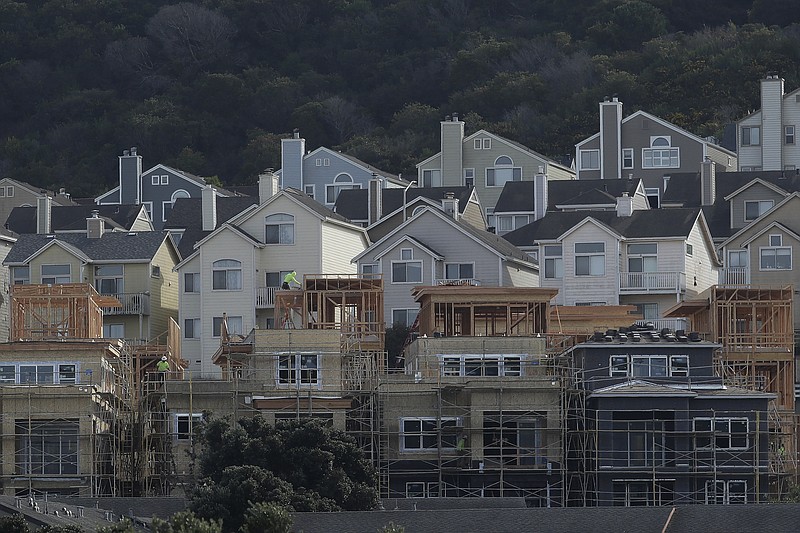 FILE - In this Feb. 20, 2020 file photo, a construction crew works on new homes in San Francisco. Your insurance policy is your safety net in case of a disaster, so you’ll want to ask a few important questions before forking over your premium. Learn what the dwelling coverage per square foot is to discover coverage gaps. (AP Photo/Jeff Chiu, File)