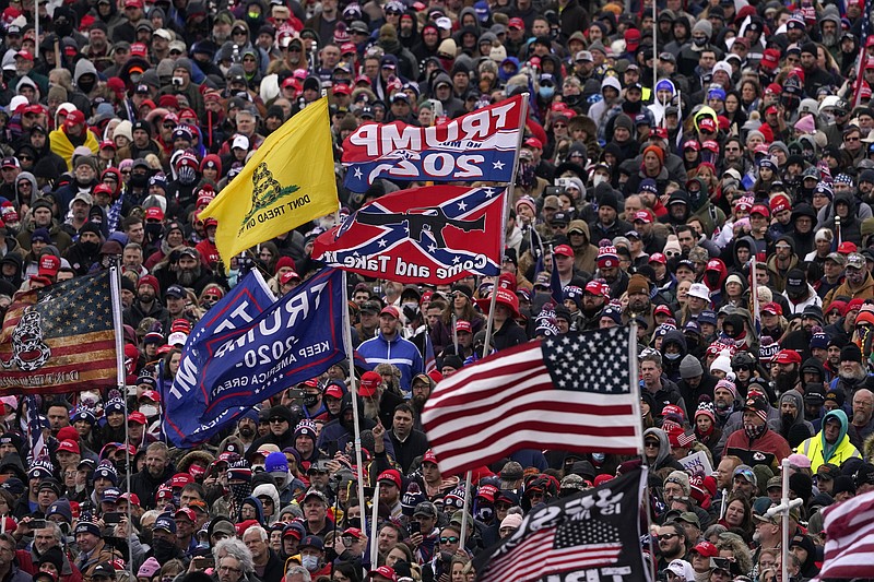 AP File Photo by Evan Vucci/In this Jan. 6 file photo, flags, including a Confederate battle flag, wave in the breeze as people listen while President Donald Trump speaks during a rally in Washington just before many of the attendees stormed the nation's Capitol.