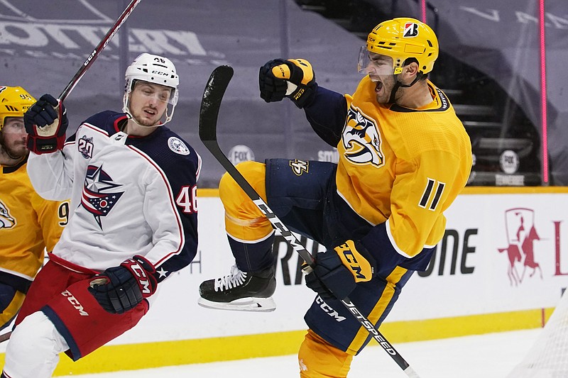 AP photo by Mark Humphrey / Nashville Predators center Luke Kunin, right, celebrates after scoring a goal against the Columbus Blue Jackets in the second period of Thursday night's season opener for both teams in Nashville. At left is Blue Jackets defenseman Dean Kukan.