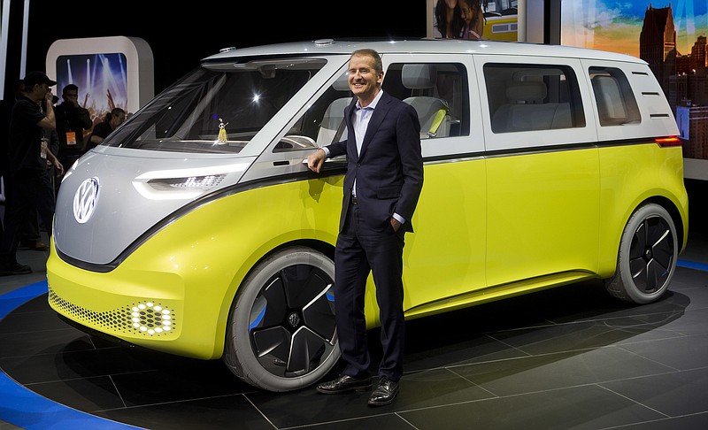 Dr. Herbert Diess, chairman of the Volkswagen brand, poses with the I.D. Buzz all-electric concept van, at the North American International Auto Show, Monday, Jan. 9, 2017, in Detroit. (AP Photo/Tony Ding)
