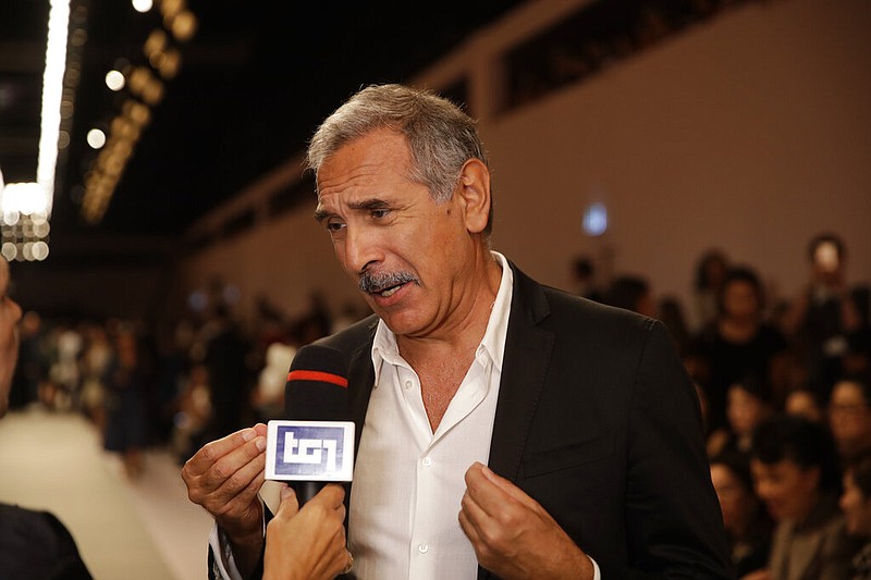 In this Thursday, Sept. 20, 2018 file photo, Carlo Capasa, head of the National Chamber of Italian Fashion, attends the Fendi women's 2019 Spring-Summer fashion show, during the Fashion Week in Milan, Italy. Italy's fashion chamber opens the first Milan Fashion Week on Friday with no VIPS populating runway front rows, as the reality of the persistent virus resurgence in Italy has forced an all-digital, no physical week of menswear previews. (AP Photo/Luca Bruno, File)