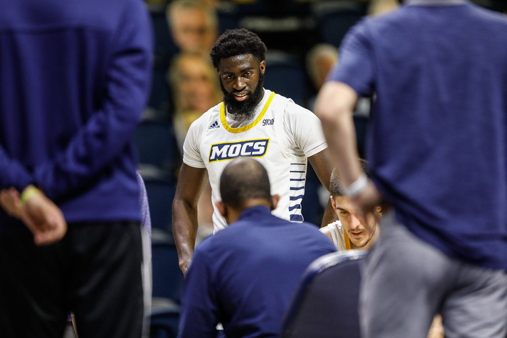 Staff photo by Troy Stolt / Chattanooga Mocs guard David Jean-Baptiste (3) listens to head coach Lamont Paris speak on a time out during the UTC men's basketball game against Wofford at McKenzie Arena on Saturday, Jan. 16, 2021 in Chattanooga, Tenn.