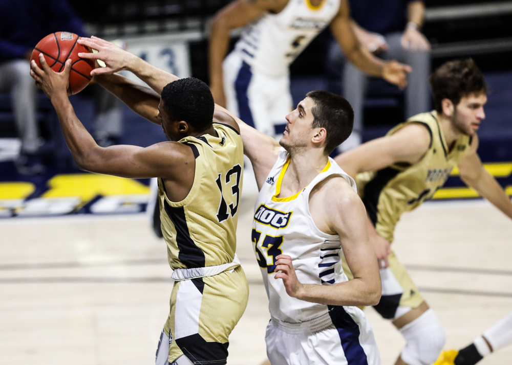 Staff photo by Troy Stolt / Chattanooga Mocs forward Stefan Kenic (33) fights for a rebound with Wofford Terriers guard Morgan Safford (13) during the UTC men's basketball game against Wofford at McKenzie Arena on Saturday, Jan. 16, 2021 in Chattanooga, Tenn.