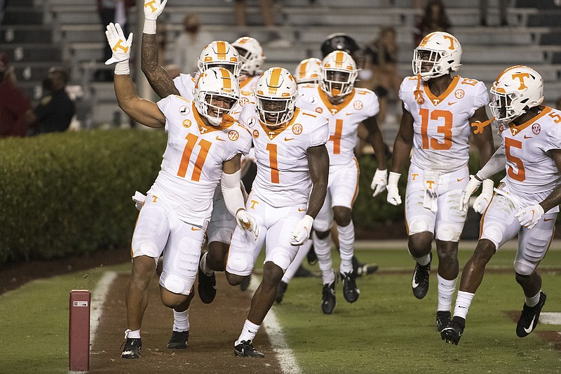 AP photo by Sean Rayford / Tennessee's Henry To'o To'o (11), Trevon Flowers (1), Deandre Johnson (13), Kenneth George Jr. (5) and their teammates celebrate an interception return for a touchdown during the Vols' win at South Carolina to open the 2020 season on Sept. 26.