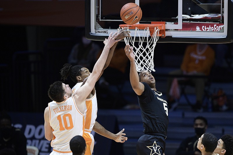 Knoxville News Sentinel photo by Calvin Mattheis via AP / Tennessee's John Fulkerson and Yves Pons fight for the rebound during Saturday night's SEC matchup with visiting Vanderbilt. The host Vols won 81-61 to extend their winning streak in the series to seven games.