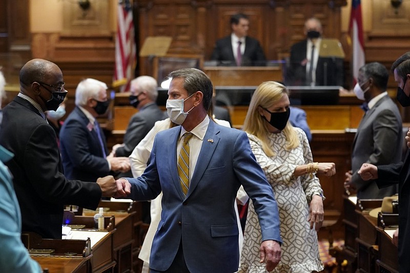 Georgia Gov. Brian Kemp and his wife Marty fist bump lawmakers as they leave the House Chamber after Kemp delivered his State of the State address Thursday, Jan. 14, 2021, in Atlanta. (AP Photo/John Bazemore)


