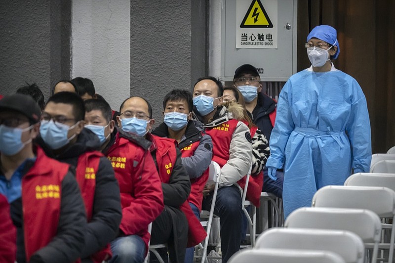 A medical worker wearing protective equipment monitors patients after they received the coronavirus vaccine at a vaccination facility in Beijing, Friday, Jan. 15, 2021. A city in northern China is building a 3,000-unit quarantine facility to deal with an anticipated overflow of patients as COVID-19 cases rise ahead of the Lunar New Year travel rush. (AP Photo/Mark Schiefelbein)


