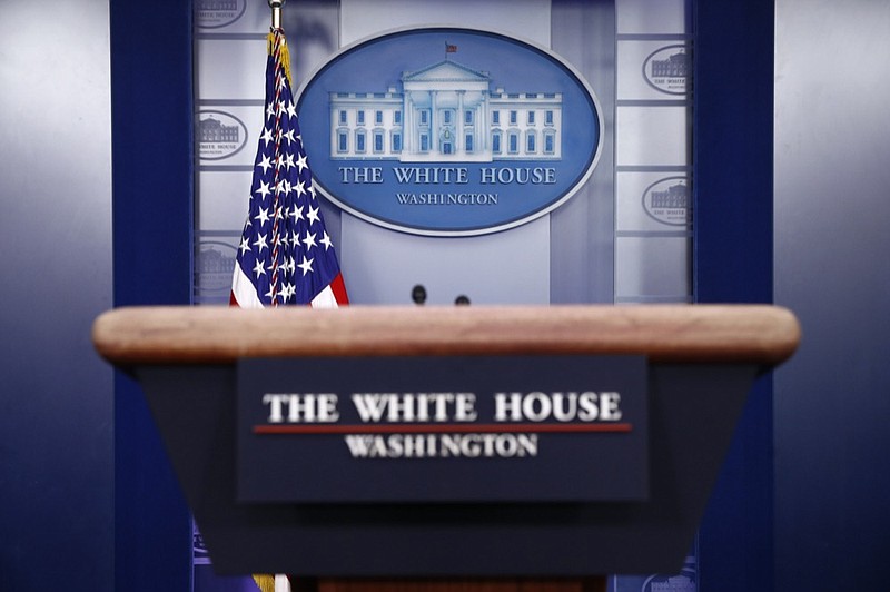 FILE - In this March 22, 2020, file photo a plaque depicting the White House is posted behind a podium in the James Brady Press Briefing Room of the White House in Washington. (AP Photo/Patrick Semansky, File)


