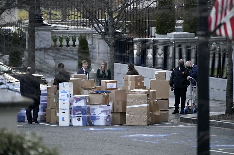 FILE - In this Jan. 14, 2021, file photo people wait for a moving van after boxes were moved out of the Eisenhower Executive Office building inside the White House complex in Washington. The public won't see President Donald Trump's White House records for years, but there's growing concern that they won't be complete, leaving a hole in the history of one of America's most tumultuous presidencies. (AP Photo/Gerald Herbert, File)


