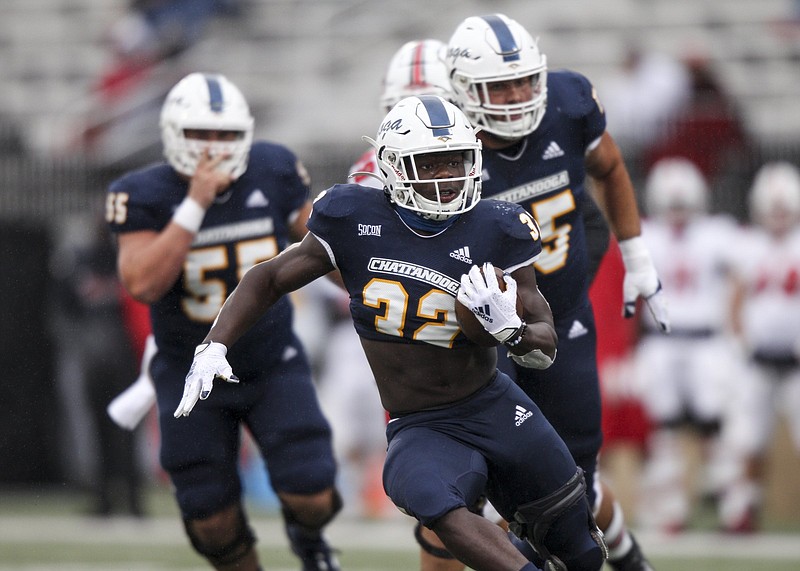 Staff photo by Troy Stolt / UTC running back Ailym Ford carries the ball during the Mocs' 13-10 loss at Western Kentucky on Oct. 24. With limited college experience at quarterback, the Mocs could count on the running game heavily during their SoCon spring schedule.