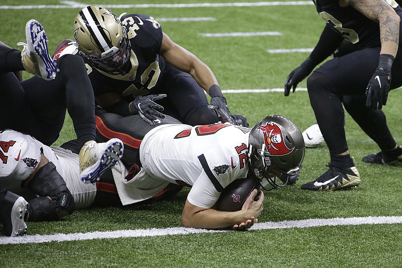 AP photo by Butch Dill / Tampa Bay Buccaneers quarterback Tom Brady scores a touchdown against the host New Orleans Saints on Sunday during the divisional round of the NFC playoffs.