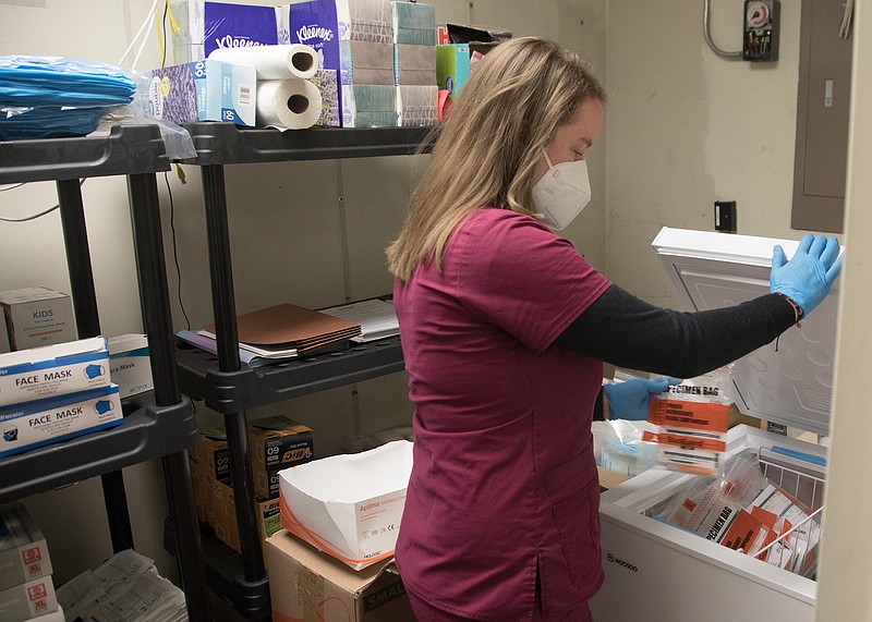 Staff photo by Troy Stolt / Healthcare worker Kristen Pennington places COVID-19 test provided by the non-profit organizations Alleo and CEMPA into a cooler at Hospice of Chattanooga on Monday, Nov. 30, 2020 in Chattanooga, Tenn.