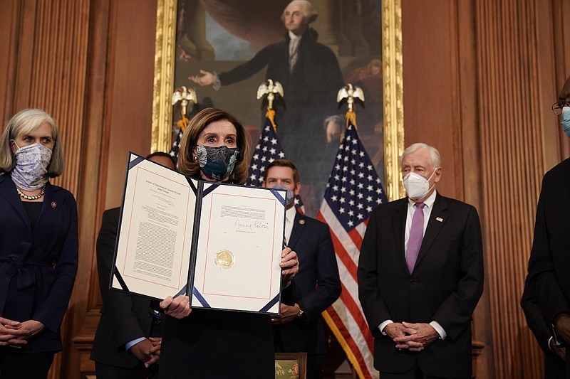 Photo by Anna Moneymaker of The New York Times / Speaker of the House Nancy Pelosi, D-California, displays the signed the article of impeachment at the Capitol in Washington on Wednesday, Jan. 13, 2021, after the House on impeached President Donald Trump for inciting a violent insurrection against the United States government.