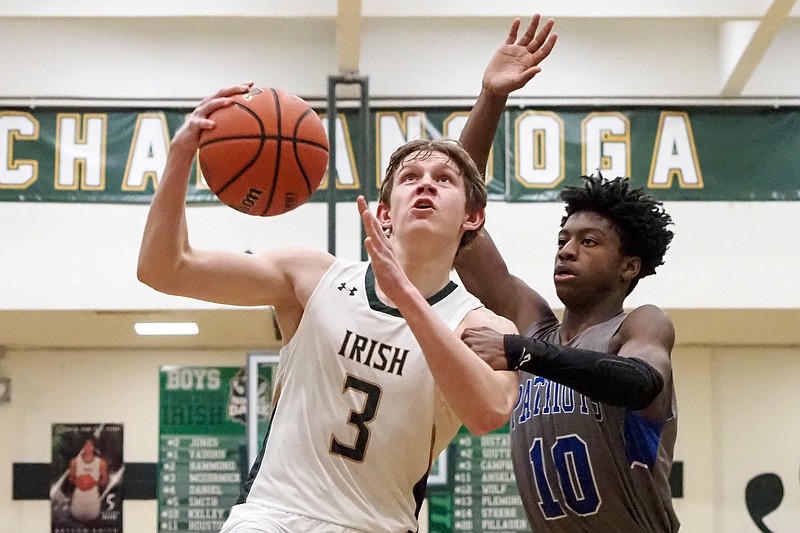 Staff photo by C.B. Schmelter / CSAS's Justin Brown (10) fouls Notre Dame's Cole McCormick (3) at Phifer Gymnasium on the campus of Notre Dame High School on Tuesday, Jan. 19, 2021 in Chattanooga, Tenn.