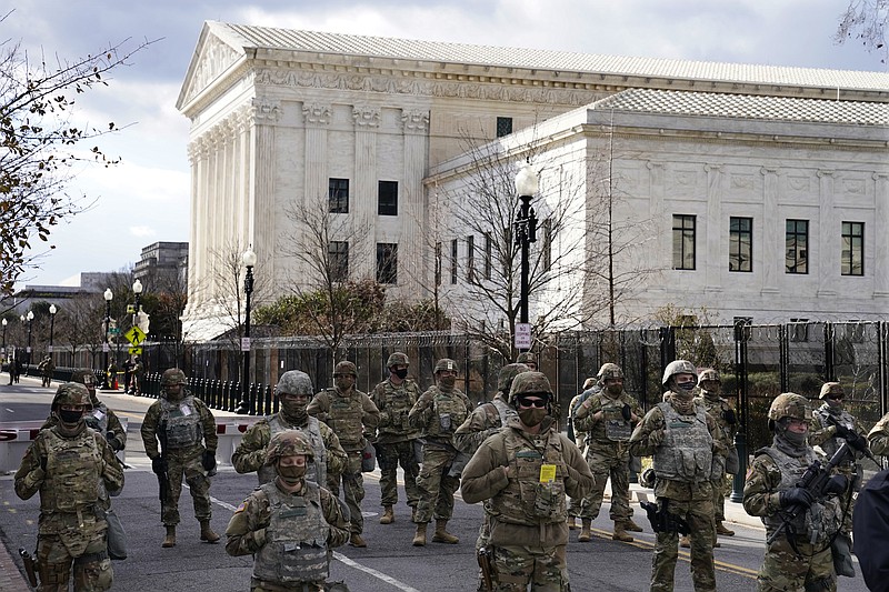 Photo by John Minchillo of The Associated Press / Members of the National Guard stand at a roadblock near the Supreme Court ahead of President-elect Joe Biden's inauguration ceremony on Wednesday, Jan. 20, 2021, in Washington.