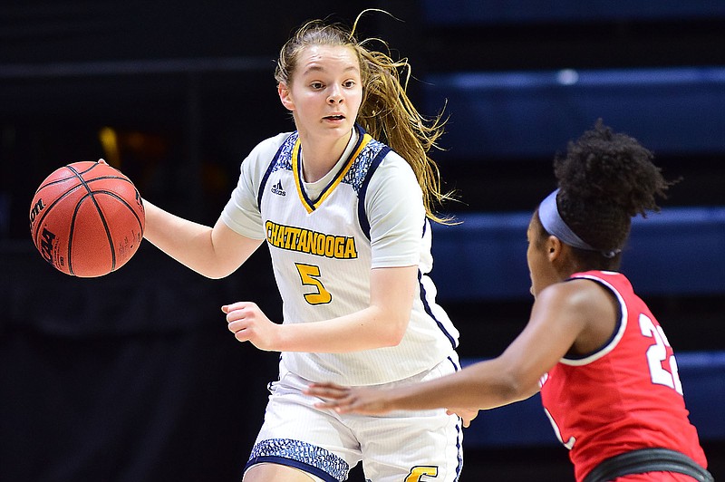 Staff photo by Robin Rudd / UTC's Sigrun Ólafsdóttir dribbles against Samford's defensive pressure during Thursday night's SoCon women's basketball game at McKenzie Arena.