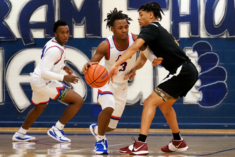 Staff photo by C.B. Schmelter / Red Bank's Kel Eddins (3) works against Tyner's Amarion Dillard (3) at Susan Ingram Thurman Gymnasium on the campus of Red Bank High School on Thursday, Jan. 21, 2021 in Chattanooga, Tenn.