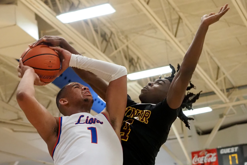 Staff photo by C.B. Schmelter / Red Bank's Cam Bell (1) goes up against Tyner's Nehemiah Bloodsaw (4) at Susan Ingram Thurman Gymnasium on the campus of Red Bank High School on Thursday, Jan. 21, 2021 in Chattanooga, Tenn.